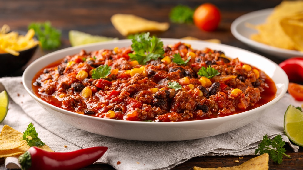 Chilli Con Carne With Tortilla Chips And Cheese In White