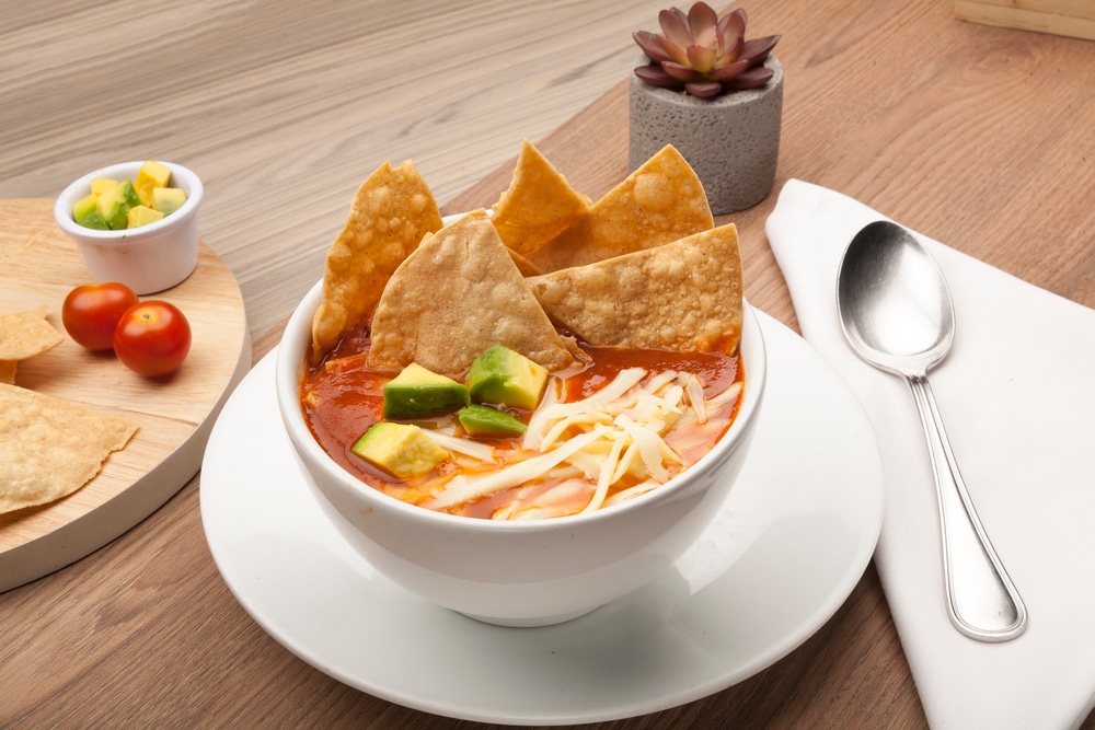 Mexican Soup With Tortilla Chips Avocado And Cheese In A