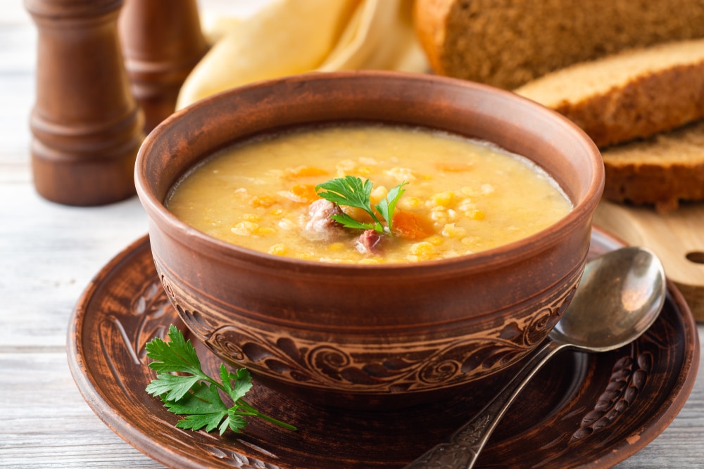 Split Pea Soup In Ceramic Bowl On Wooden Table Selective