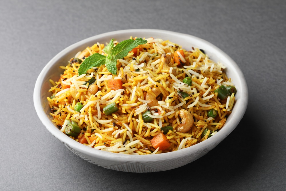 Veg Biryani Or Veg Pulav in a white dish