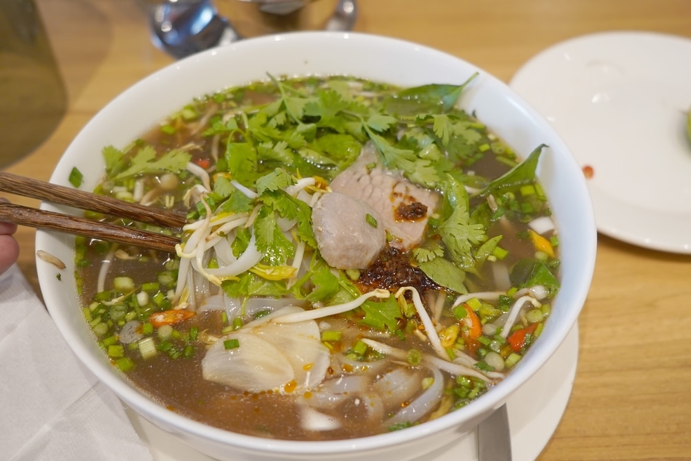 A Bowl Of Pho On A Wooden Table The Pho