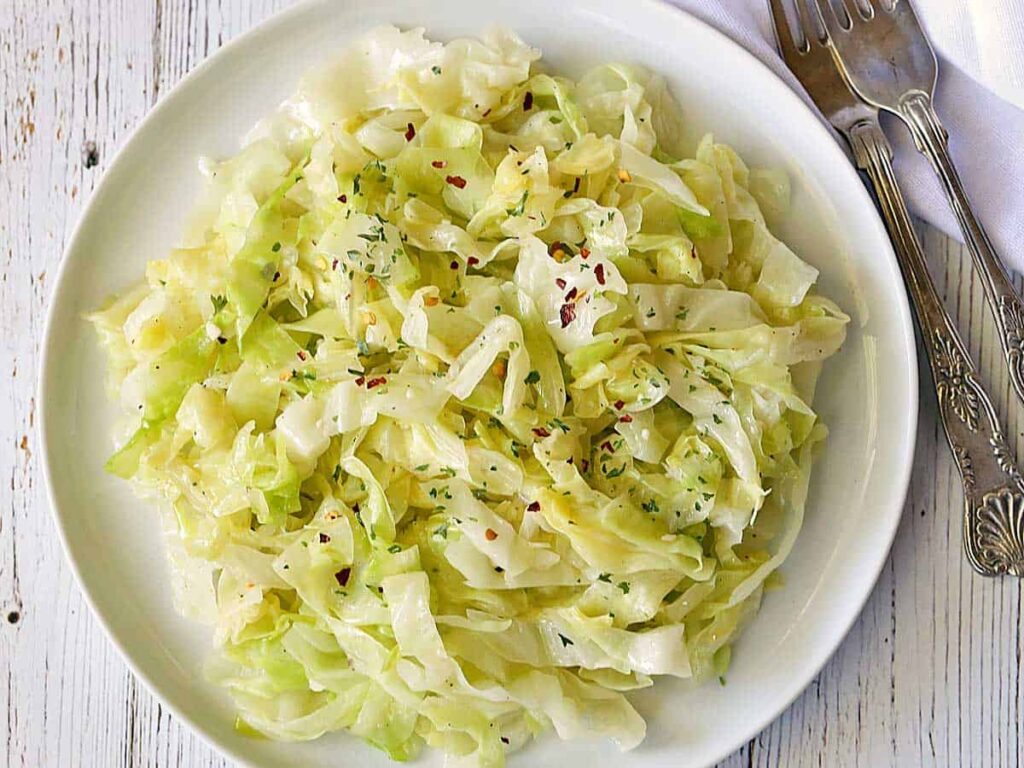 A top view of cabbage seasoned with red chili flakes