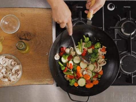 A top view of veggies being sauteed in a pan