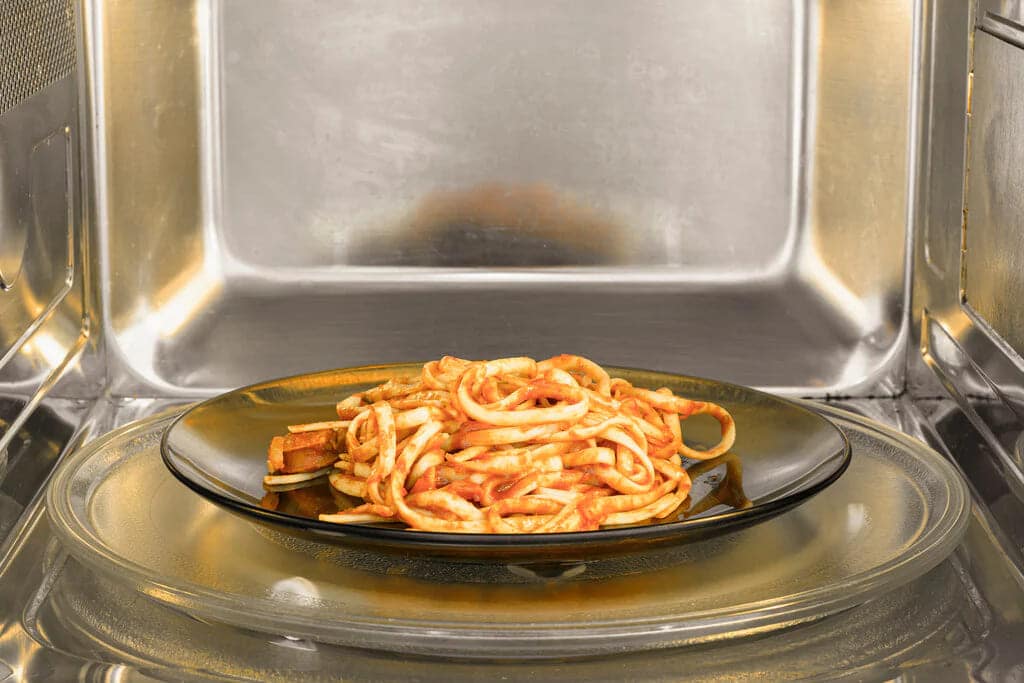 A veggie pasta being warmed up in the oven