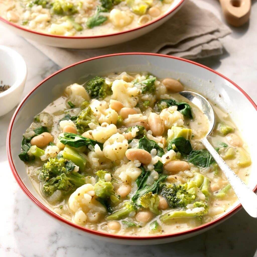 A view of Arborio Rice and White Bean Italian Soup in a bowl with a spoon