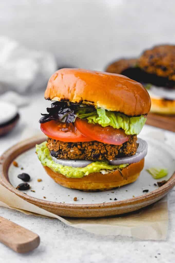 A view of a Veggie bun black bean burger with tomatoes and lettuce