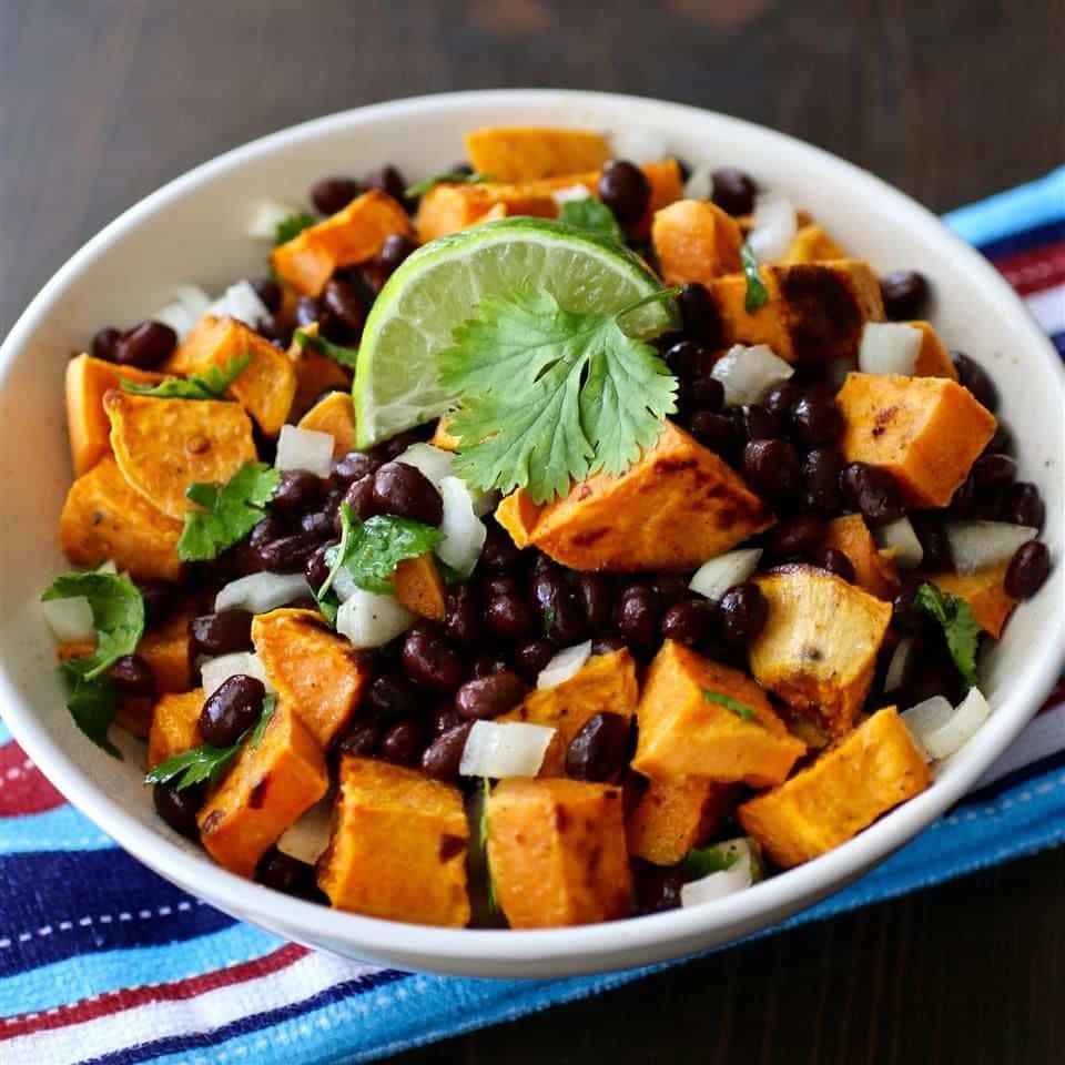 A view of black bean and potato salad with lemon and cilantro garnish