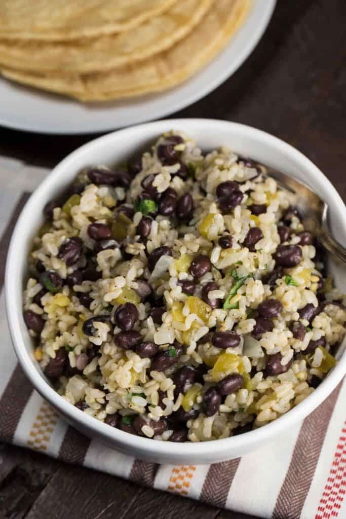 A view of black beans and rice in a white bowl