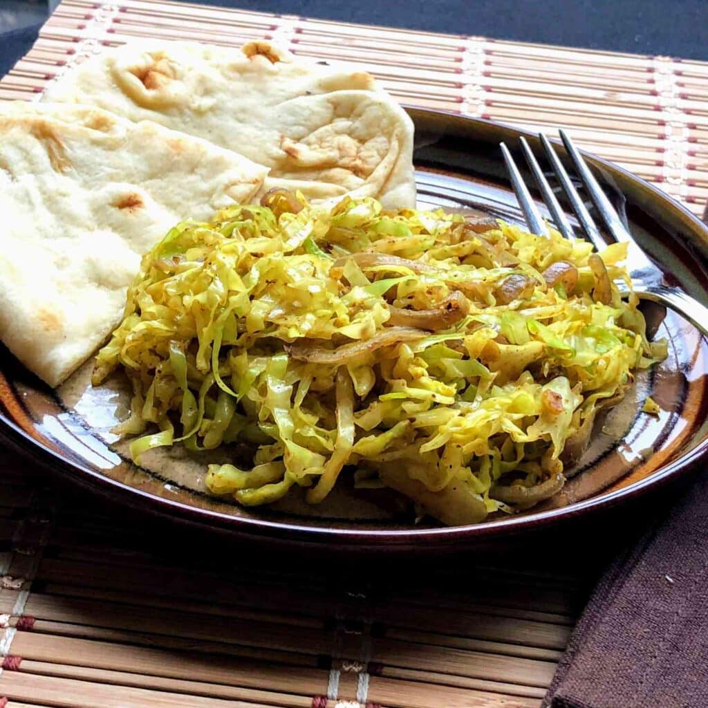 A view of indian fried cabbage plated with indian bread