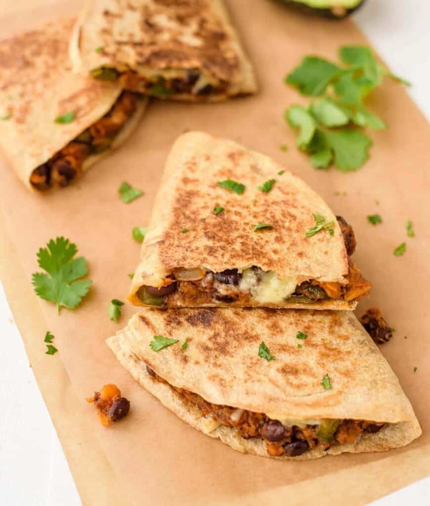 A view of sweet potato quesadillas with cilantro garnish