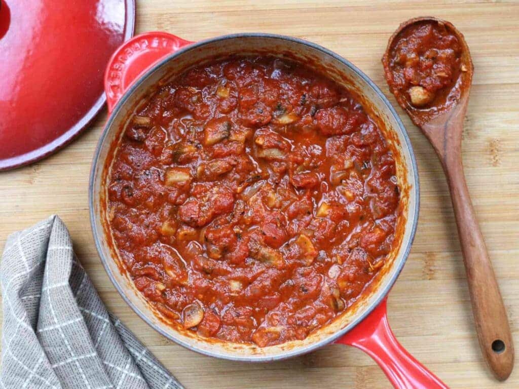 An overhead view of a vegetarian tomato pasta sauce in a pan