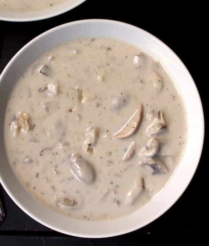 An overhead view of creamy mushroom soup inside a bowl