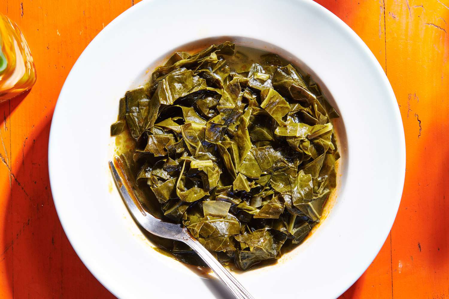 A top view of collard greens plated out with a fork