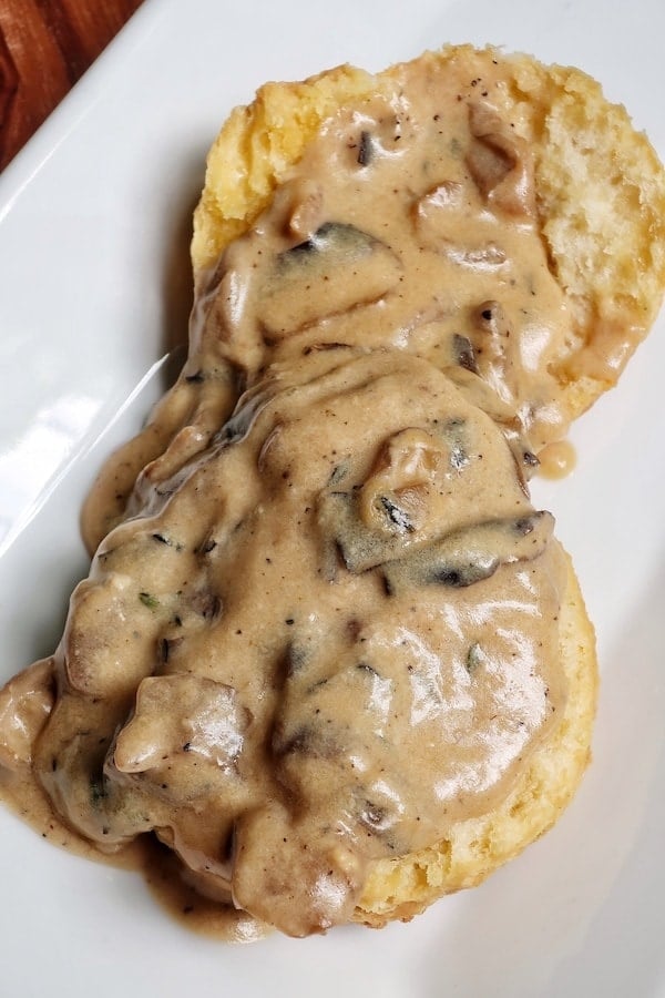 A top view of vegetarian mushroom gravy served with veggie biscuits