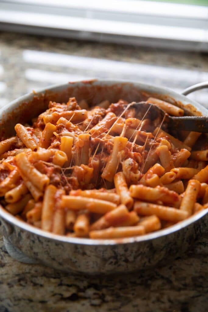 A view of a cheesy ziti pasta inside a bowl