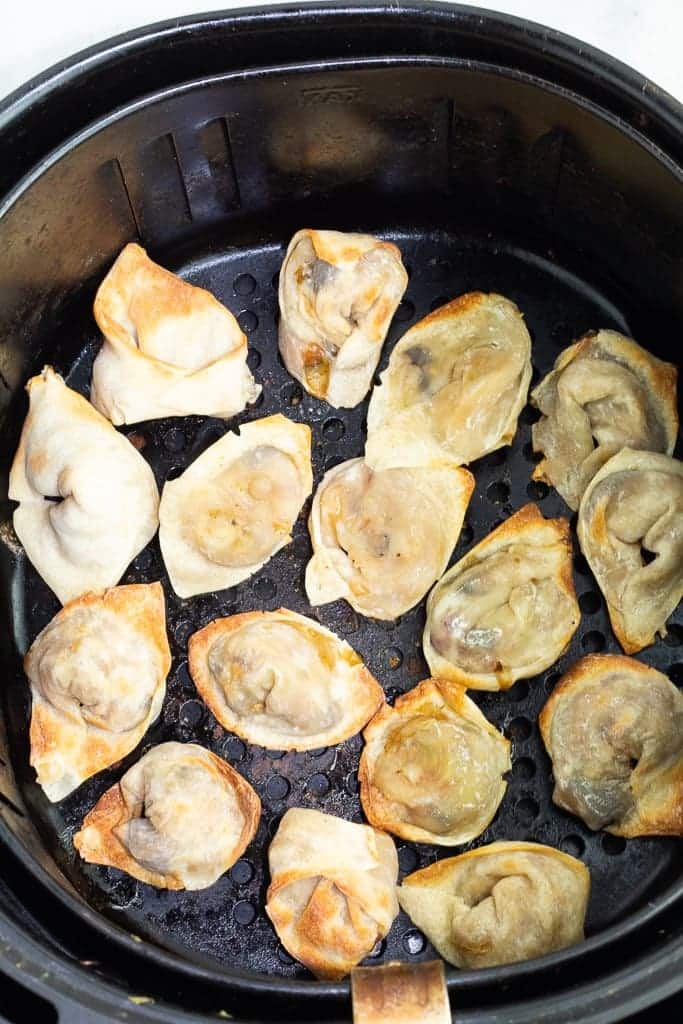 A view of dumplings being fried in a pan