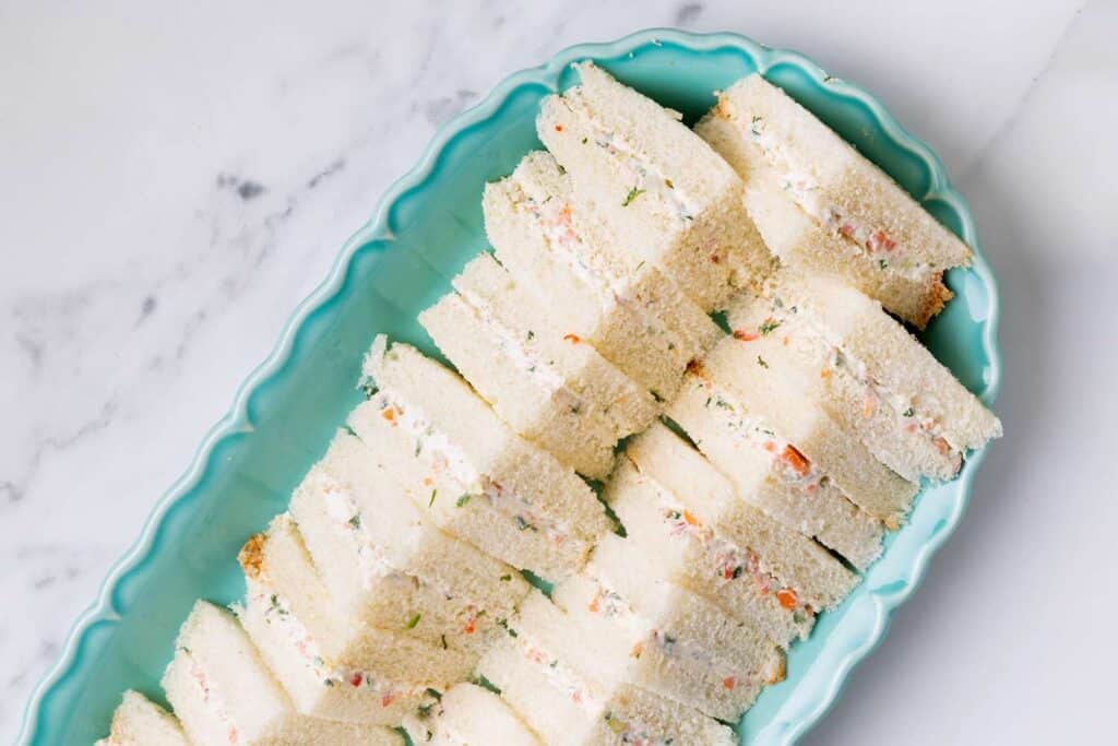 An overhead view of sliced triangular cut veggie sandwiches