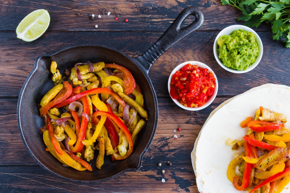 An overhead view of vegetable fajitas in a pan