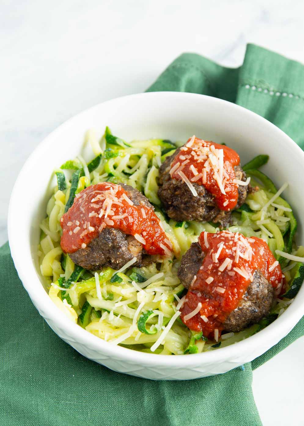 A view of vegetarian meatballs recipe served with salad topped with tomato sauce