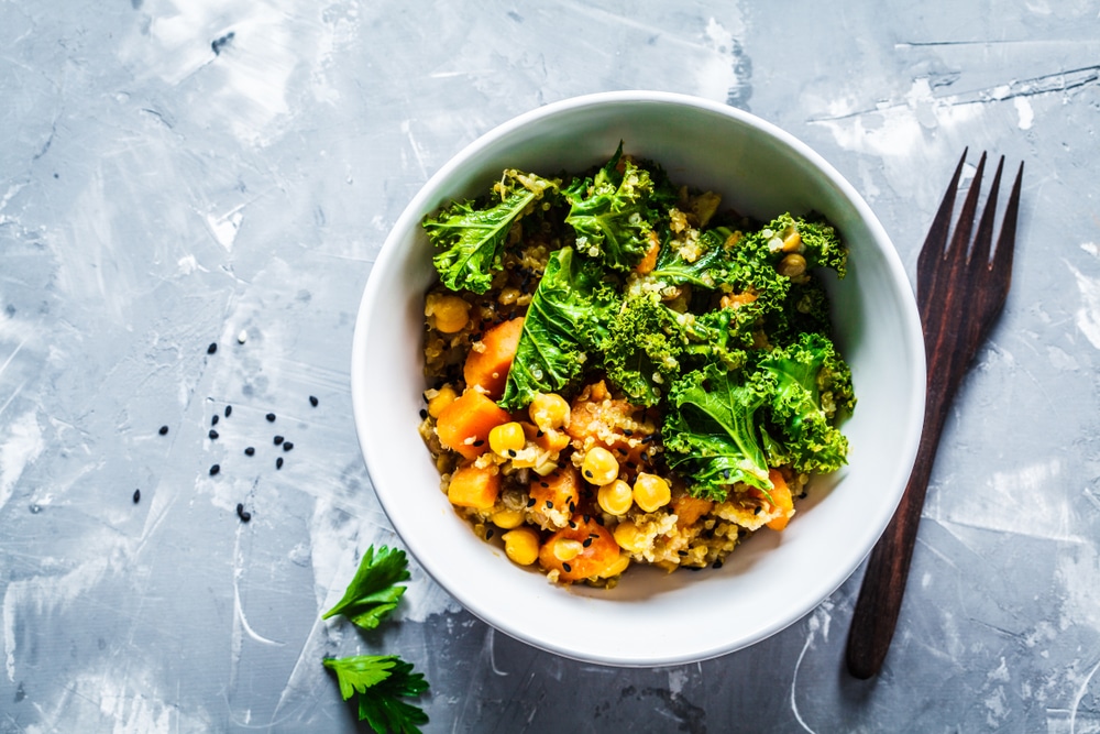 A top view of a bowl of kale and sweet potato salad