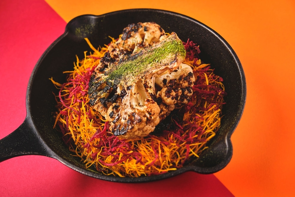 A view of a smoked cauliflower inside a pan