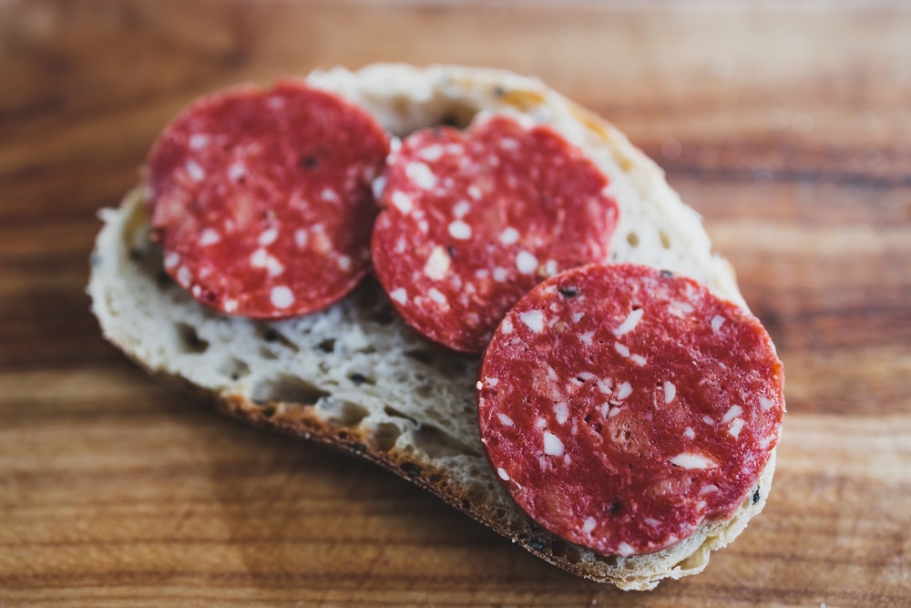 A view of vegan pepperoni slices on bread