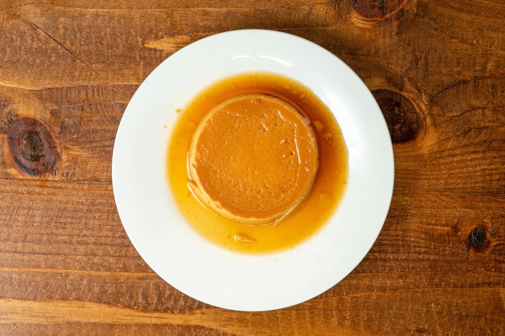 An overhead view of a flan on white plate